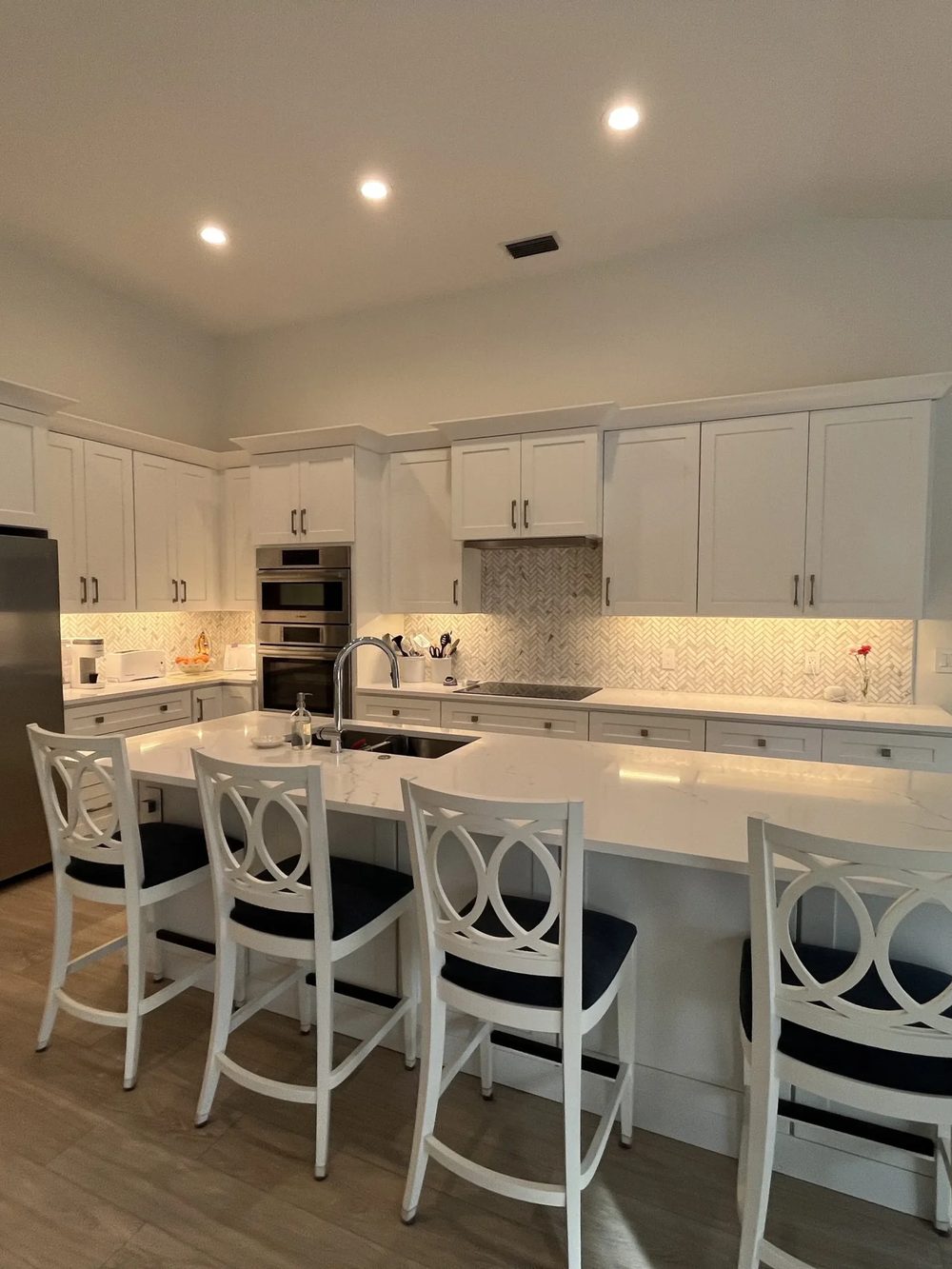 White kitchen remodel with large island and seating