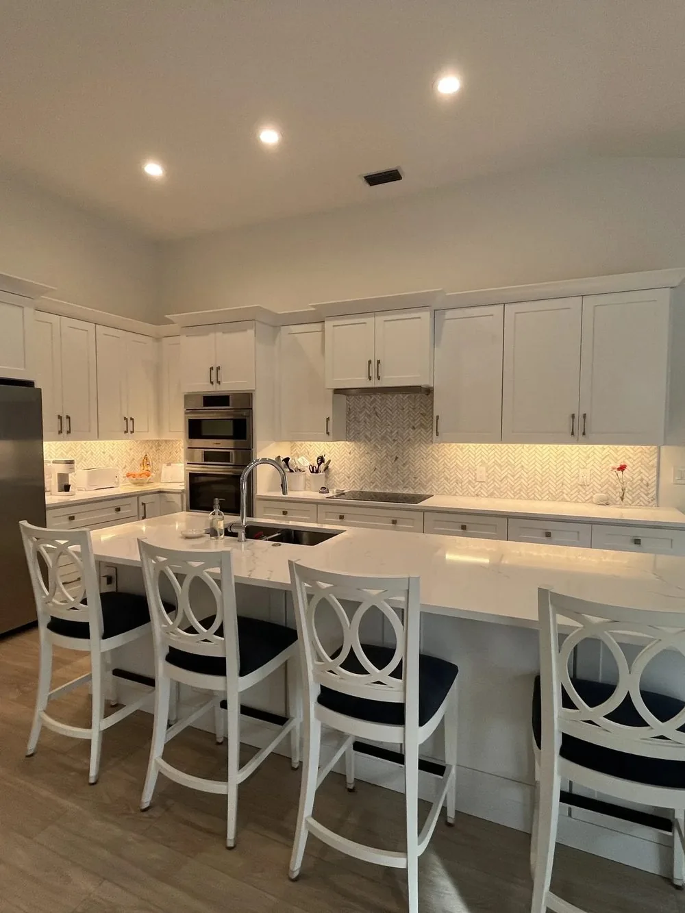 White kitchen remodel with large island and seating
