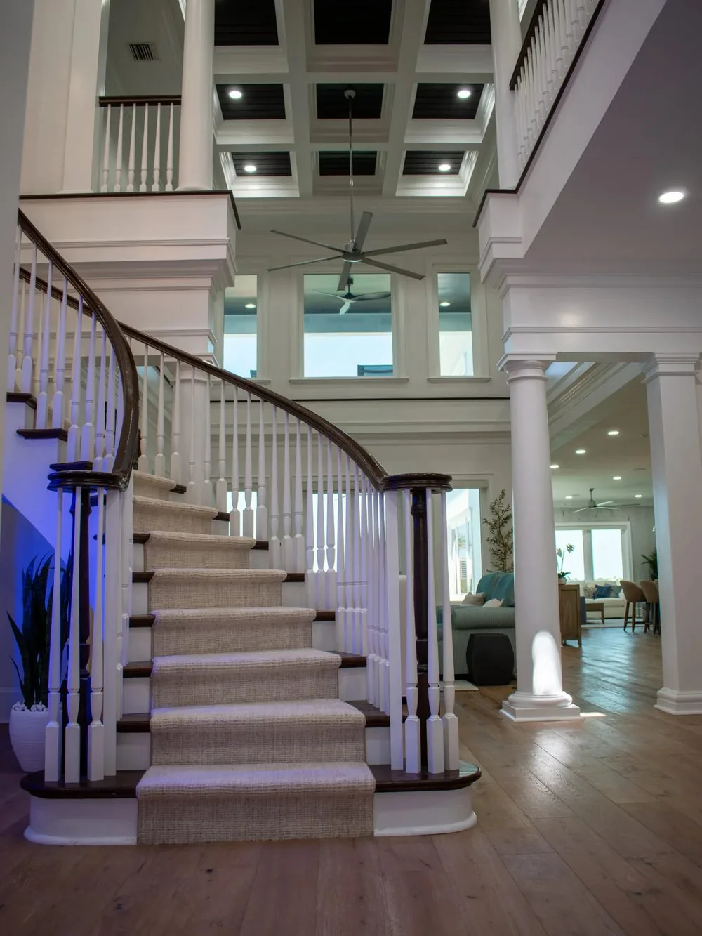Two-story foyer with curved staircase from a whole house remodel